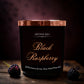 Luxury black raspberry and vanilla scented candle in a black glass container with gold lid. 