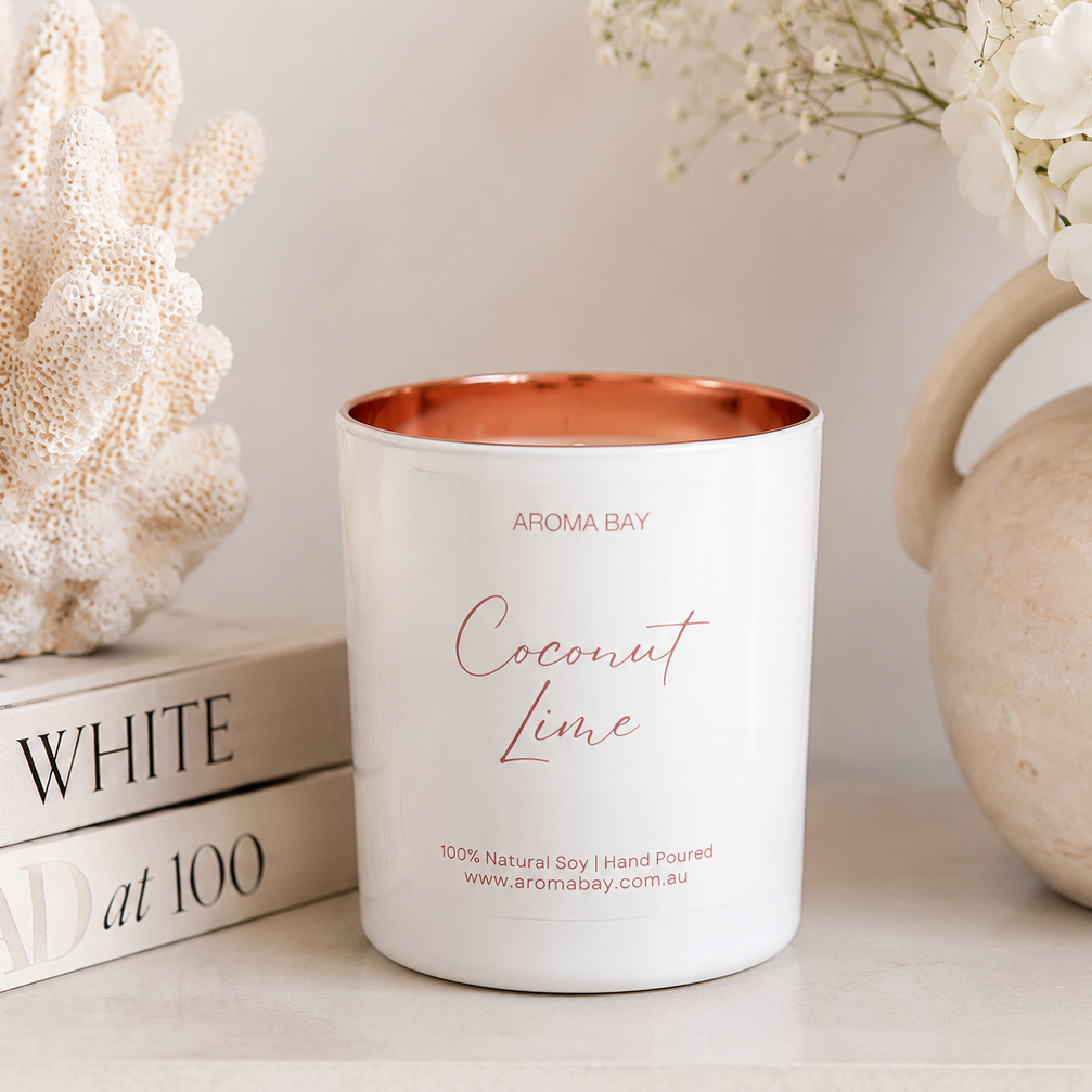 Coconut Lime candle with rose gold interior on a shelf with decorative items
