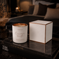Aroma Bay Candle and its packaging on a marble surface with a blurred background