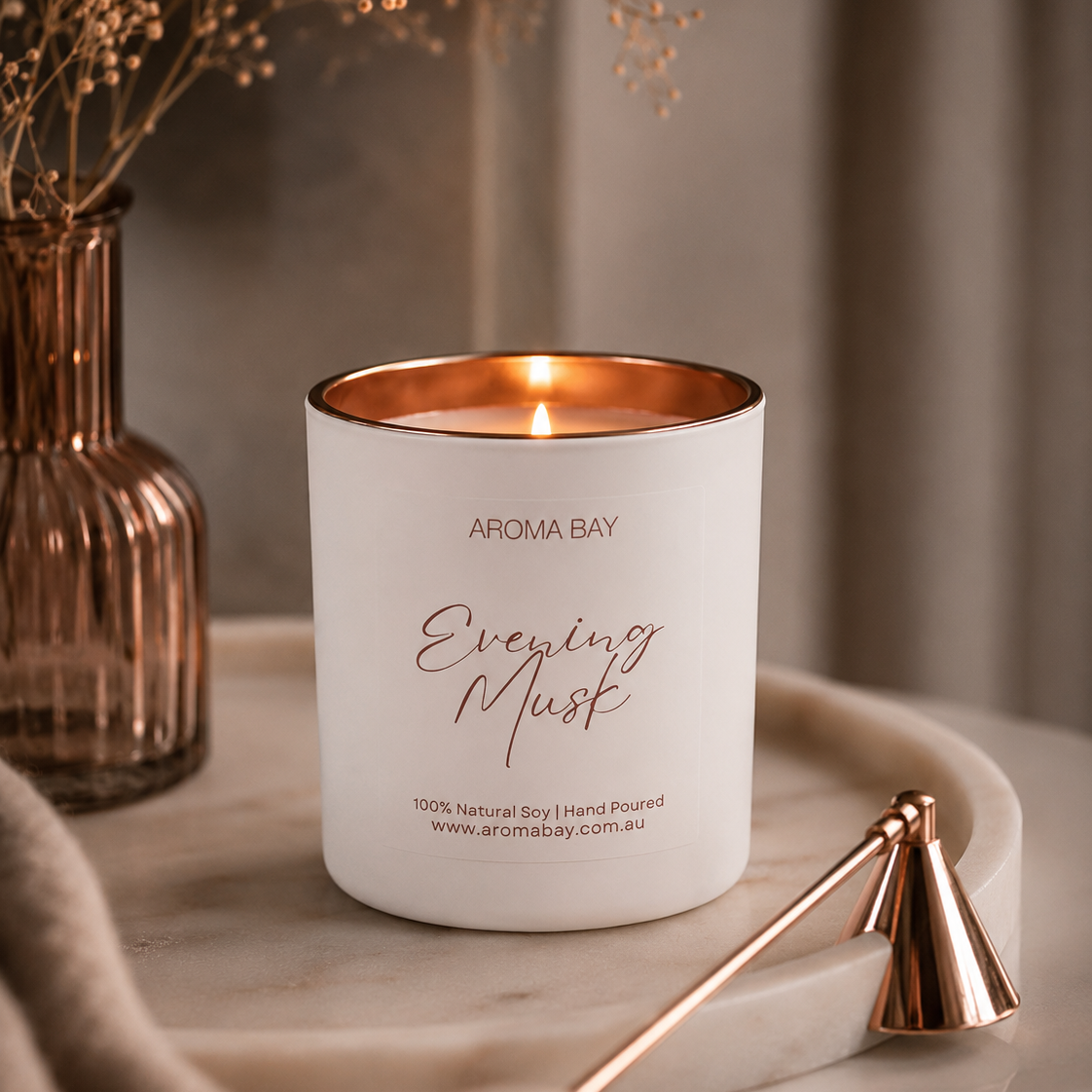Aroma Bay candle labeled 'Everying Musk' on a wooden surface with decorative elements.